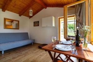 a living room with a table and a blue couch at Secluded holiday house Milovcici, Krk - 14604 in Malinska