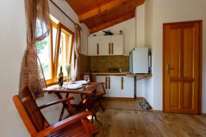 a small kitchen with a wooden table and a dining room at Secluded holiday house Milovcici, Krk - 14604 in Malinska