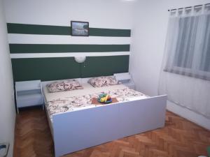 a small bedroom with a bed with a tray of fruit on it at Rooms with a parking space Lukovo, Senj - 14567 in Sveti Juraj