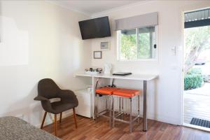 a living room with a chair and a desk at Amaroo Park in Cowes