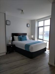 a bedroom with a large bed and a large window at Apartment 3 Wallaroo Marina in Wallaroo