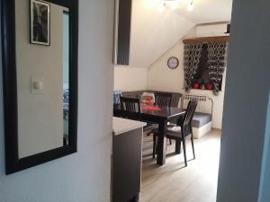 a kitchen and dining room with a table and chairs at Apartments with a parking space Smoljanac, Plitvice - 14657 in Smoljanac