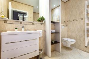 a bathroom with a white sink and a toilet at Apartments and rooms with WiFi Zagreb - 14675 in Zagreb