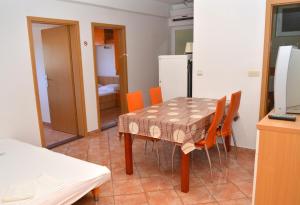 a kitchen and dining room with a table and chairs at Apartment Gradac 13681d in Gradac