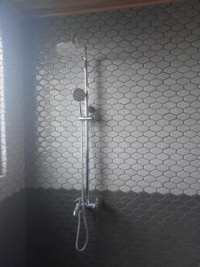 a shower in a bathroom with white tiled walls at Hillcrest Ella in Ella