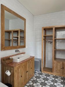 a bathroom with a sink and a mirror at The Seaglass Villas Bingin in Uluwatu