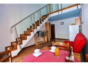 a living room with a red table and a staircase at Apartments and rooms by the sea Stanici, Omis - 14783 in Omiš +22 photos