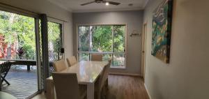 a dining room with a table and a large window at Shelleys House in Rainbow Beach