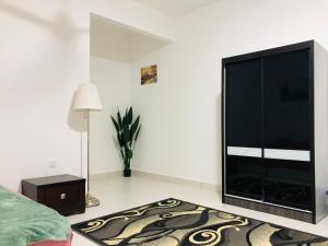 a living room with a large flat screen tv at Alyn Home Batu Pahat IV Wifi Cuckoo in Batu Pahat