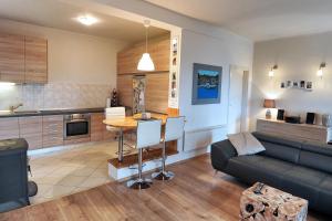 a kitchen and living room with a couch and a table at Holiday house with a swimming pool Hreljin, Kraljevica - 14813 in Hreljin