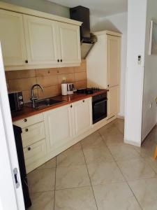 a kitchen with white cabinets and a sink at Apartments by the sea Postira, Brac - 14822 in Postira