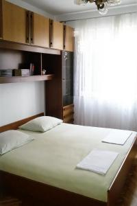 a large bed in a room with a window at Apartments with WiFi Omis - 14843 in Omiš