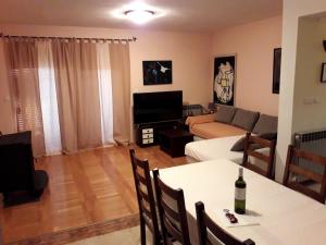 a living room with a couch and a table at Holiday house with a parking space Zadar - 14848 in Zadar