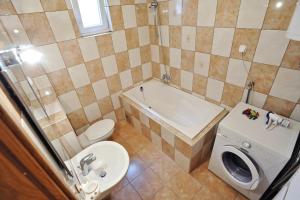 a bathroom with a toilet and a tub and a sink at Holiday house with a parking space Zadar - 14848 in Zadar +14 photos