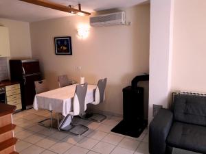a dining room with a table and a couch at Holiday house with a parking space Zadar - 14848 in Zadar