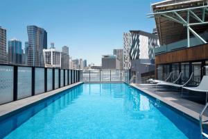 a large swimming pool on the roof of a building at Peppers Docklands in Melbourne