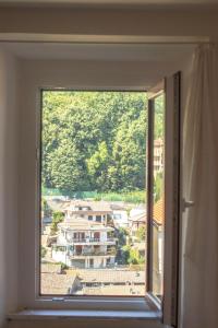 a window with a view of a city at Jo Sedio Residenza, Bellezza e Relax Monti Lepini in Carpineto Romano