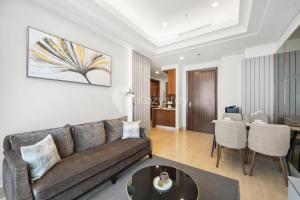 a living room with a couch and a table at Ebony by Kozystay - Setiabudi in Jakarta