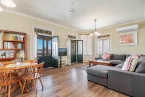 a living room with a couch and a table at Ballina Heritage Inn in Ballina