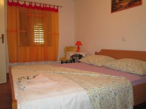 a bedroom with a bed with two towels on it at Seaside holiday house Cove Bristva, Korcula - 14892 in Prizba