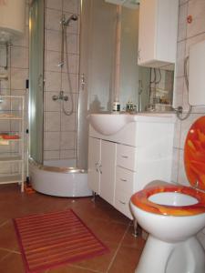 a bathroom with a toilet and a sink and a shower at Seaside holiday house Cove Bristva, Korcula - 14892 in Prizba