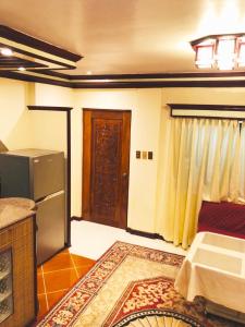 a living room with a refrigerator and a door at THE MANSION- Near NAIA Airport Terminal PASAY in Manila