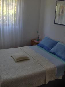 a bed with two towels on it in a bedroom at Apartments with a parking space Milna, Brac - 14961 in Milna