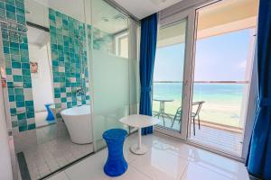 a bathroom with a view of the ocean at Hamdeok Beach Stay Jeju in Jeju