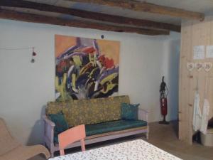 a living room with a couch and a painting on the wall at Apartments with a parking space Porozina, Cres - 14980 in Filozići