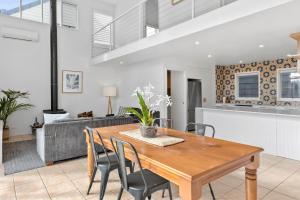 a kitchen and dining room with a wooden table and chairs at Terrace Lofts Apartments in Ocean Grove