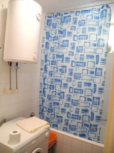 a bathroom with a toilet and a shower curtain at Apartments with WiFi Split - 15028 in Split