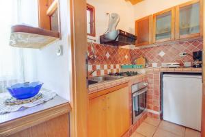 a kitchen with a sink and a stove top oven at Apartments with a parking space Mali Losinj (Losinj) - 15050 in Mali Lošinj +13 photos