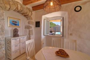 a dining room with a table and a window at Family friendly house with a swimming pool Babino Polje, Mljet - 14926 in Babino Polje