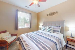 a bedroom with a bed with a ceiling fan and a window at Butler's Place in Flagstaff