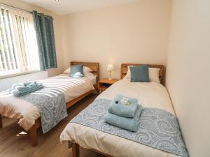 a bedroom with two beds with towels on them at Cedar Holme in Chesterfield