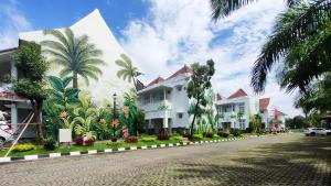 a building with a mural on the side of a street at Al Azhar Azhima Hotel Resort and Convention in Solo