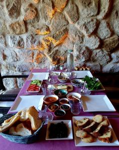 a table with three trays of food on it at Alphan Cappadocia in Uchisar