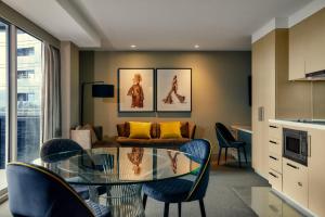 a living room with a glass table and chairs at The Kinson in Melbourne