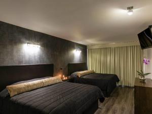 Postel nebo postele na pokoji v ubytování Suites Meson Del Cid