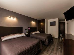 Postel nebo postele na pokoji v ubytování Suites Meson Del Cid