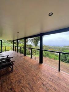 a house with a deck with a view of the wilderness at Tematas Mountain Villa in Avarua