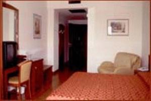 a living room with a bed and a television at Hotel Corone in Caerano di San Marco +7 photos