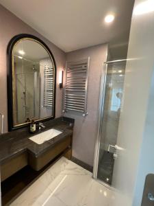 a bathroom with a sink and a mirror at Family luxury Apartment 2 BEDROOM +SALOON in Istanbul
