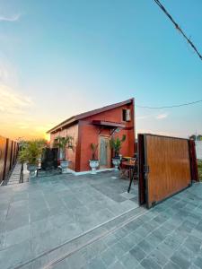 a small house on a patio with a fence at Ginza Bungalow Yogyakarta in Demangan