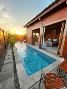 a swimming pool in front of a house at Ginza Bungalow Yogyakarta in Demangan