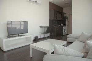 a living room with a tv and a couch and a table at Rafa Homes in Riyadh