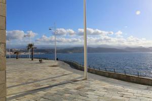 a walkway next to a large body of water at Casa Lucy in Las Palmas de Gran Canaria