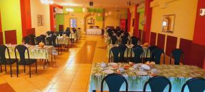 a banquet hall with tables and chairs in a room at Hotel Krokus in Kamienna Góra