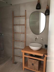 a bathroom with a sink and a mirror at Mezzao in Kounopetra