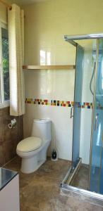 a bathroom with a toilet and a glass shower at บ้านรับพร in Nakhon Phanom